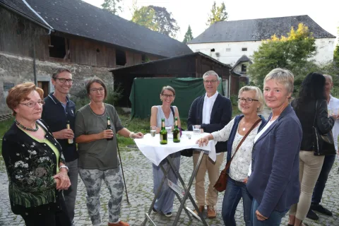 Fünf Gäste an einem Stehtisch