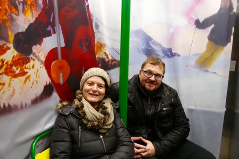 Ein Paar sitzt im Sessellift des Fotopunkts.