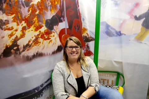 Eine Besucherin sitzt lachend im Sessellift des Fotopunkts.
