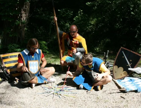 Eine Gruppe von Menschen sitzt auf dem Boden und spielt ein Spiel