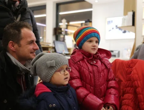 Ein Mann mit zwei Kindern in Winterkleidung