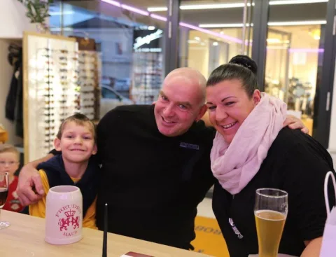 Zwei Mitarbeiter und ein Junge an der Theke