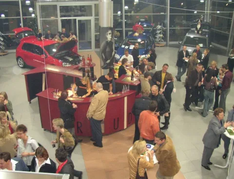 Blick von oben über den Ausstellungsraum mit Bar und Auto