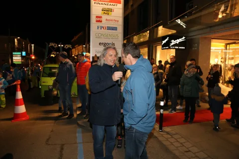 Zwei Männer mit Mikrofon vor dem Publikum